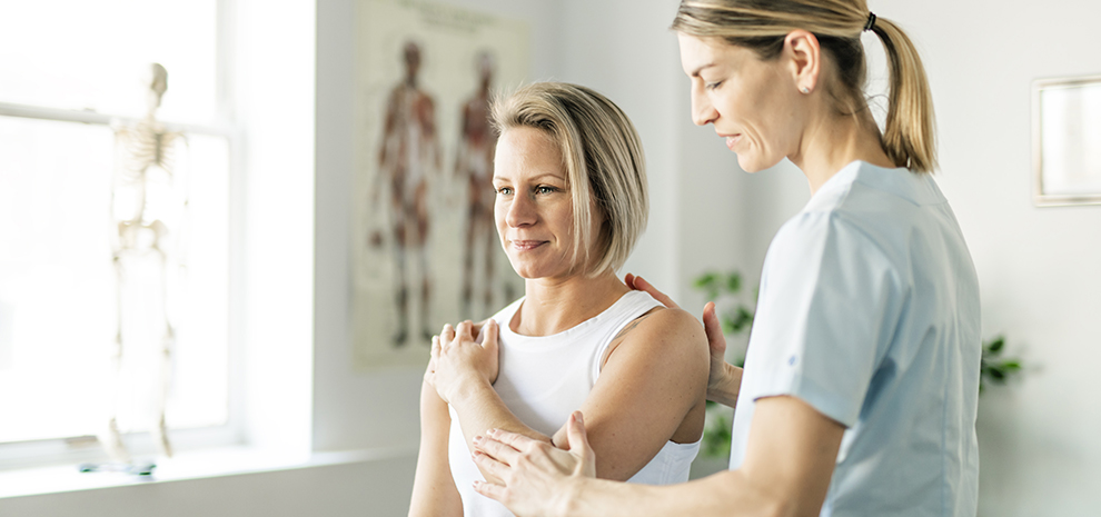 Modern rehabilitation physiotherapy worker with woman client